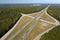 Elevated view of freeway exit junction over road lanes with fast moving traffic cars and trucks. Interstate