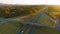 Elevated view of freeway exit junction over road lanes with fast moving traffic cars and trucks in North Carolina golden