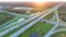 Elevated view of freeway exit junction over road lanes with fast moving traffic cars and trucks at sunrise. Interstate