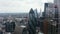 Elevated view of Gherkin skyscraper. Backwards reveal of group of modern tall office buildings in City financial hub