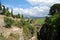 Elevated view of the old bridge crossing the ravine with views towards the countryside, Ronda, Spain.