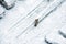 Elevated view of people walking during snow on frozen street wit