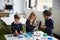 Elevated view of three primary school kids working together using construction blocks in a classroom