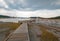 Elevated wooden boardwalk going past Black Warrior Hot Springs and Tangled Creek into Hot Lake in Yellowstone National Park