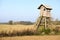 Elevated wooden hunting blind in a field