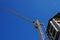 Elevating crane against the dark blue sky