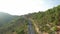 Elevating over cyclist on high slope mountain road