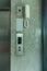 Elevator button and white telephone