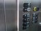 Elevator lift buttons, modern stainless steel interior.