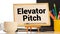 elevator pitch text message on white paper and office supplies, pen, paper note, on white desk