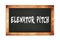 ELEVATOR  PITCH text written on wooden frame school blackboard