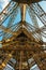 Elevator shaft on the eiffel tower in a wide angle shot showing the big copper lights.