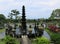 Eleven-levels fountain in the water palace. Promenade in tropical garden. Tropical garden with palm and many colorful flowers.