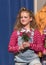 Eleven-year old girl standing holding flowers on stage in school play