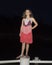 Eleven year old girl standing on a post at night