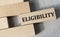 ELIGIBILITY - word on a wooden bar on a gray background