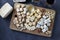 Elite cheeses: with truffle, dor blue, brie, parmesan and assortment of nuts on a wooden board on gray background. Wine party