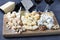 Elite cheeses: with truffle, dor blue, brie, parmesan and assortment of nuts on a wooden board. Wine party snack