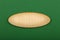 Ellipse shaped wooden sign on green background