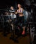 Elliptical walker trainer man and woman at black gym