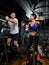 Elliptical walker trainer man and woman at black gym