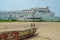 Elmina, Ghana - February 13, 2014: Elmina castle with wooden fishing boat and beach in foreground