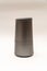 elongated cylinder-shaped speaker on a white background with bluetooth