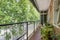 Elongated terrace of a house with clay tile floors, a metal and glass cabinet