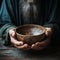 Emaciated hands hold an empty bowl against wood, depicting the reality of hunger