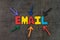 Email, electronic mail sending or newsletter concept, multi color arrows pointing to the word EMAIL at the center of black cement