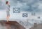 Email icons and Businesswoman standing on Roof with chimney and cloudy city