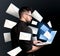 Email spam. Young man with laptop and many letters on black background