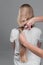 Emale hairdresser hold in hand between fingers lock of blonde hair, comb and scissors closeup. Image of hairdresser trimming ends