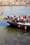 From the embankment of the Douro River sails pleasure boat with tourists. Cheerful mood and dinner