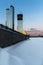 Embankment near Moscow City. Sunset on the Moscow River in winter. Capital Towers high-rise buildings under construction