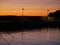 Embankment in the port. Yacht masts and ships sway on waves. Evening. Lantern