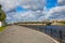 Embankment of the river Volga in Tver, Russia. Road the old Volga bridge on the horizon. Picturesque river landscape