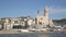 Embankment of Spanish city of Sitges with views of beach and Church of St. Bartholomew and Santa Tecla on sunny autumn