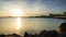 Embankment with stones passes over the Black sea against the backdrop of a sunny sky