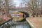 Embankment Tiergartenufer of the Landwehr Canal bridged by the Berlin Stadtbahn with a moving train and houseboats