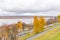 Embankment of the Volga river in Nizhny Novgorod. The Kremlin walls are made of red stone. Car parking. Autumn cloudy day