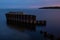 Embedded stones and harbor ruins in Narva-JÃµesuu. Rocky beach, peaceful sea and port.