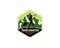 Emblem logo of sherpa trekker pulling travois walking on the ground in front of mountains