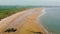 Embleton Bay and Burn beach with the ruins of Dunstanburgh Castle