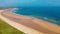 Embleton Bay and Burn beach with the ruins of Dunstanburgh Castle