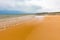 Embleton Bay and Burn sandy beach with the ruins of Dunstanburgh Castle