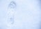 Embossed footprint on white snow. Winter time, copy space for text