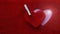 Embossed heart in textured red fabric along with a wooden white clothespin. The concept of love, feelings, wedding. Banner