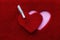 Embossed heart in textured red fabric along with a wooden white clothespin. The concept of love, feelings, wedding. Banner