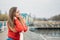 Embrace being single, Art of Being Happily Single. Woman in red jacket walks by the river alone. calm scene